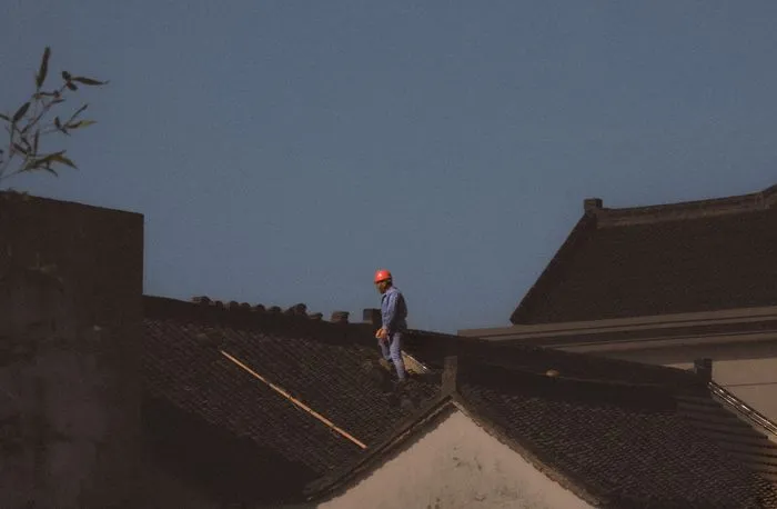 Roofing contractor reviewing a shingle warranty document with homeowner