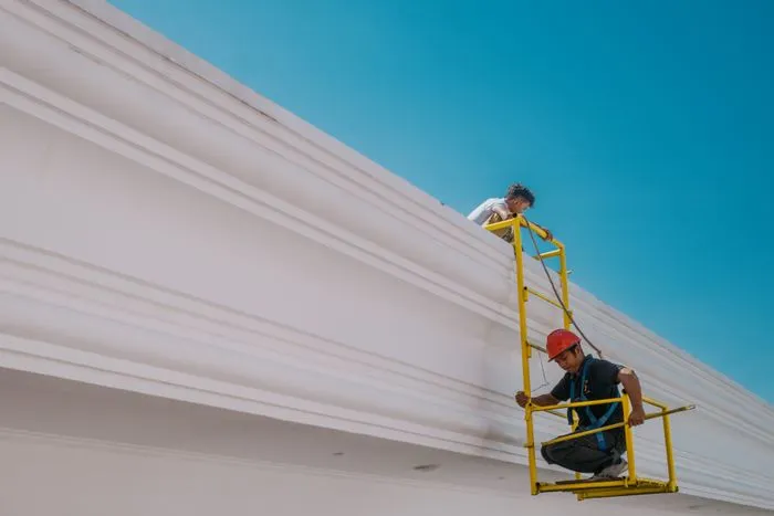Roofing contractor inspecting a residential roof in Houston